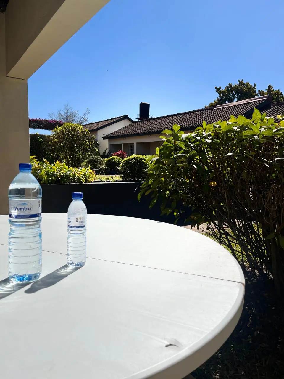 Outdoor guest table overlooking the lodge gardens